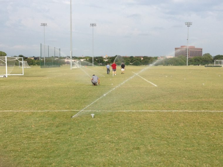 Irrigation students testing their sprinklers and using catch cans to measure application rates.